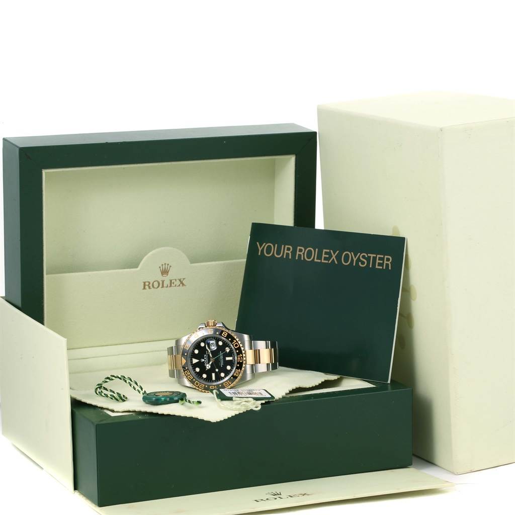 The Rolex GMT-Master 116713 Men's Stainless Steel Black Dial 116713 Men's Stainless Steel Black Dial watch is displayed in its open box with accessories, including manuals and a tag, viewed from the front.