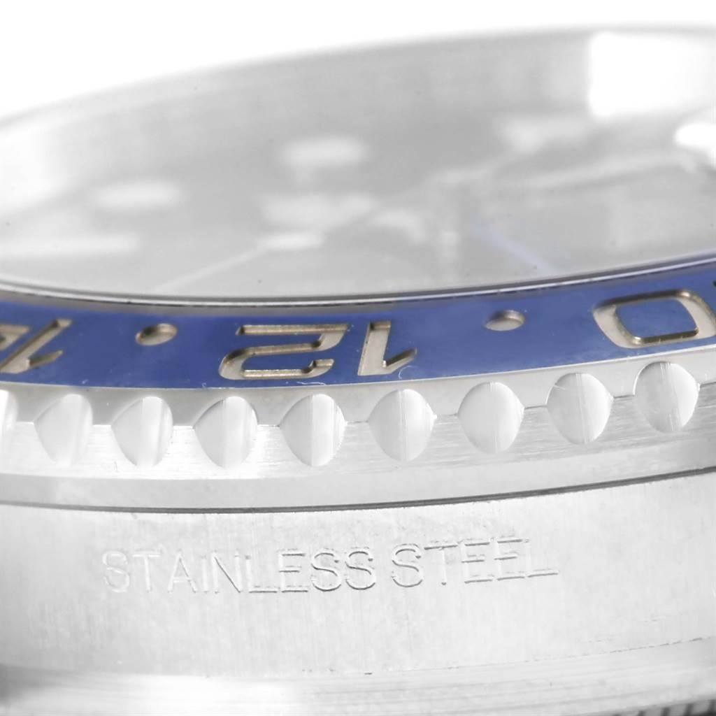 This close-up angle of the Rolex GMT-Master 116710BLNR Men's Stainless Steel Black Dial 116710BLNR Men's Stainless Steel Black Dial watch shows the bezel with some markers and part of the stainless steel case.