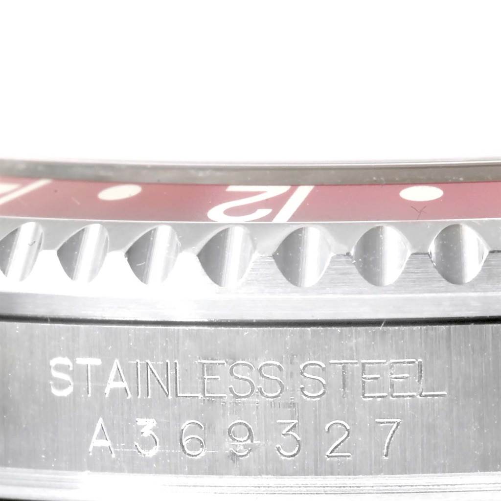 This close-up image shows the stainless steel bezel and serial number engraving on a Rolex GMT-Master 16710 Men's Stainless Steel Black Dial 16710 Men's Stainless Steel Black Dial watch.