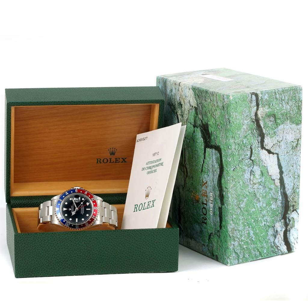 The image shows a Rolex GMT-Master 16710 Men's Stainless Steel Black Dial 16710 Men's Stainless Steel Black Dial watch with its box and documentation, displayed at an oblique angle.