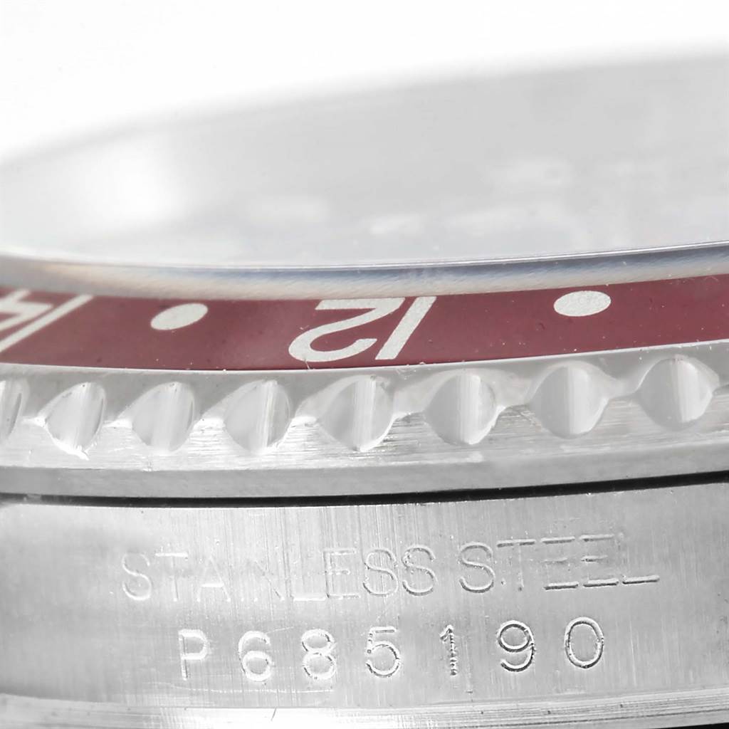 Close-up of the Rolex GMT-Master 16710 Men's Stainless Steel Black Dial 16710 Men's Stainless Steel Black Dial showing the stainless steel case, partial bezel with “12” marker, and serial number.