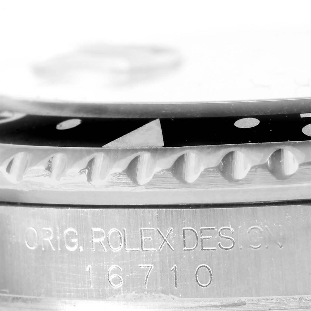 The image shows a close-up of the bezel and case side of a Rolex GMT-Master 16710 Men's Stainless Steel Black Dial 16710 Men's Stainless Steel Black Dial, model number 16710.