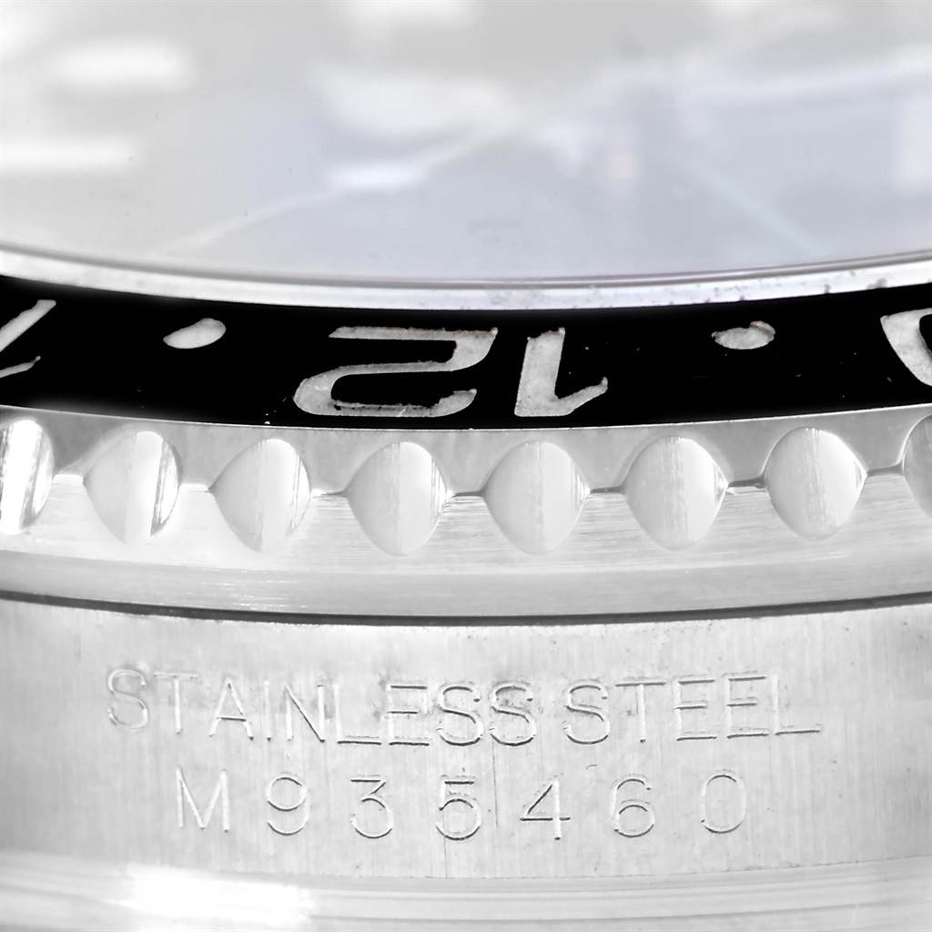 This close-up image shows the bezel and case side of a Rolex GMT-Master 116710 Men's Stainless Steel Black Dial 116710 Men's Stainless Steel Black Dial, highlighting the "STAINLESS STEEL" engraving and serial number.