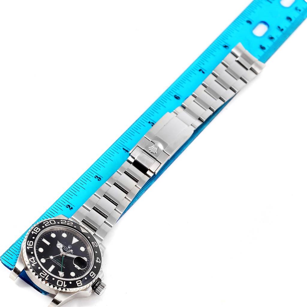 The image shows a Rolex GMT-Master 116710 Men's Stainless Steel Black Dial 116710 Men's Stainless Steel Black Dial watch laid flat against a blue ruler, displaying the watch face and bracelet.