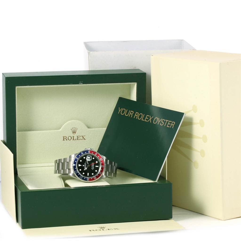 The image shows a Rolex GMT-Master 16710 Men's Stainless Steel Black Dial 16710 Men's Stainless Steel Black Dial watch from the front, placed inside its branded box with accompanying documents.