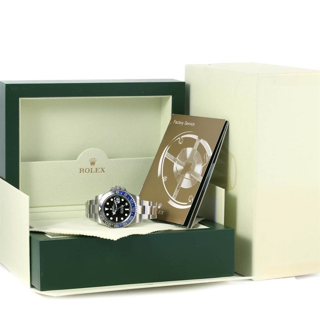 The image shows a Rolex GMT-Master 116710 Men
s Stainless Steel Black Dial 116710 Men
s Stainless Steel Black Dial watch presented in its box along with a factory service booklet.