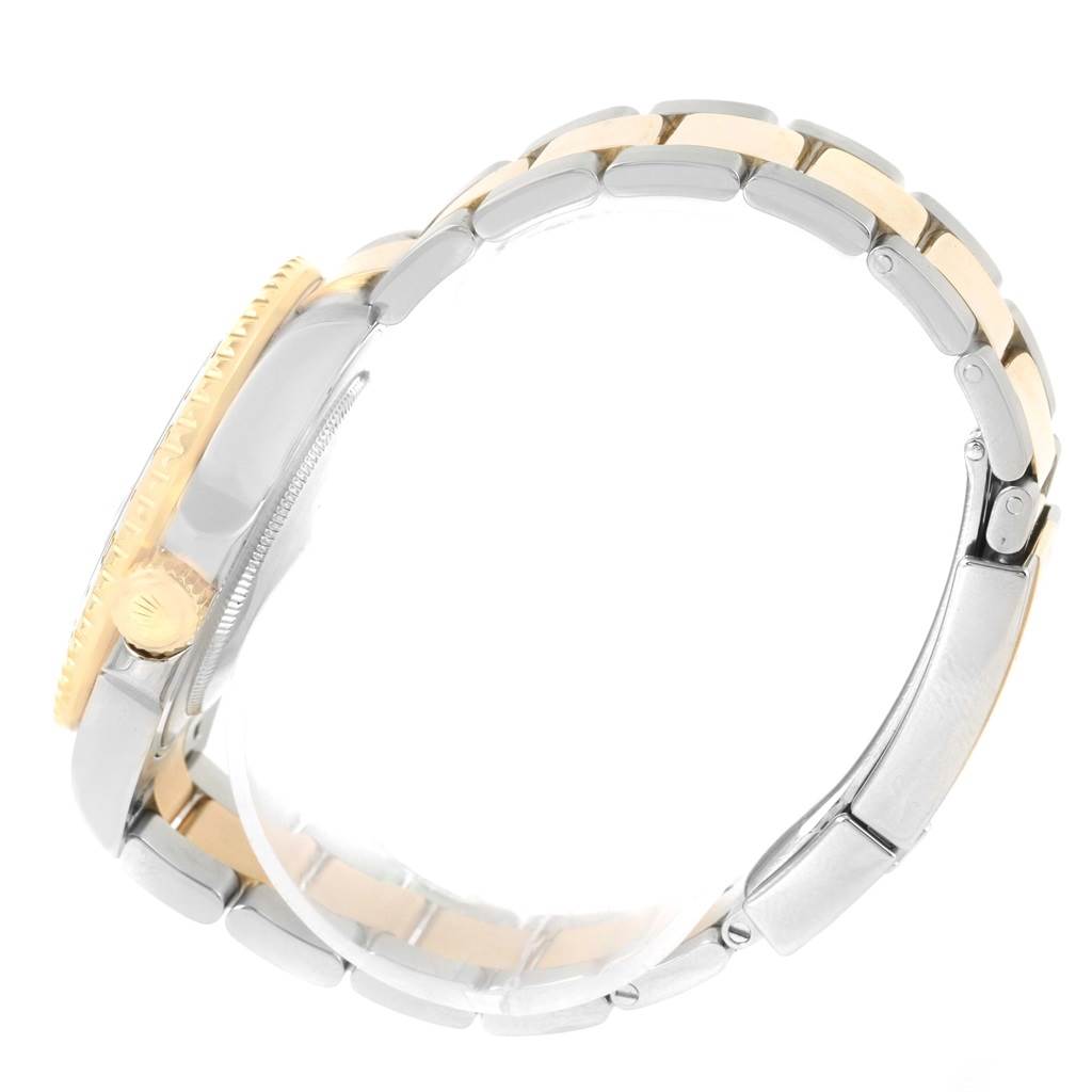 This side angle view of the Rolex GMT-Master 116713 Men's Stainless Steel Black Dial 116713 Men's Stainless Steel Black Dial watch shows the two-tone bracelet and part of the crown.