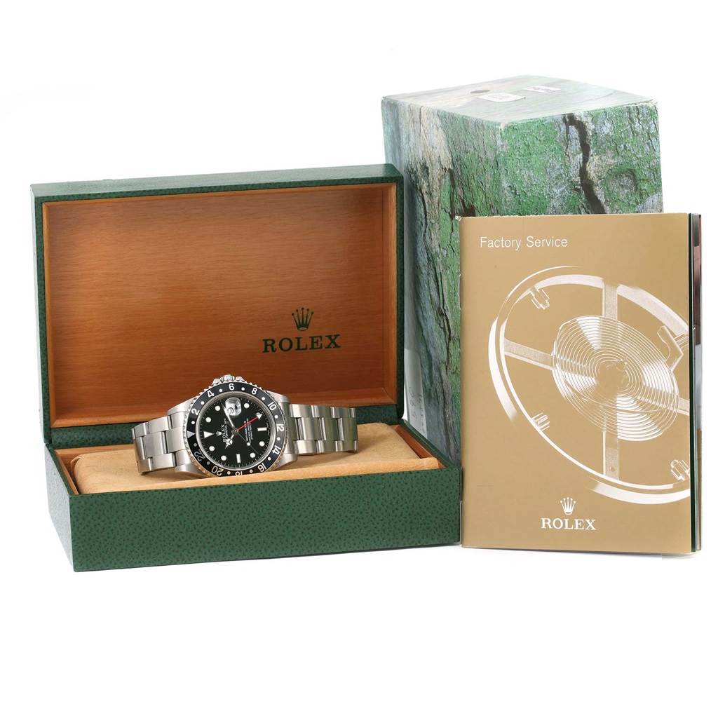 The image shows a Rolex GMT-Master 16710 Men's Stainless Steel Black Dial 16710 Men's Stainless Steel Black Dial watch in its open box alongside a service booklet and outer packaging.