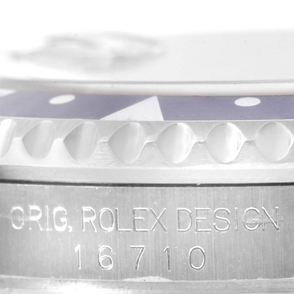 This close-up image shows the side engraving and bezel of a Rolex GMT-Master 16710 Men's Stainless Steel Black Dial 16710 Men's Stainless Steel Black Dial model 16710.