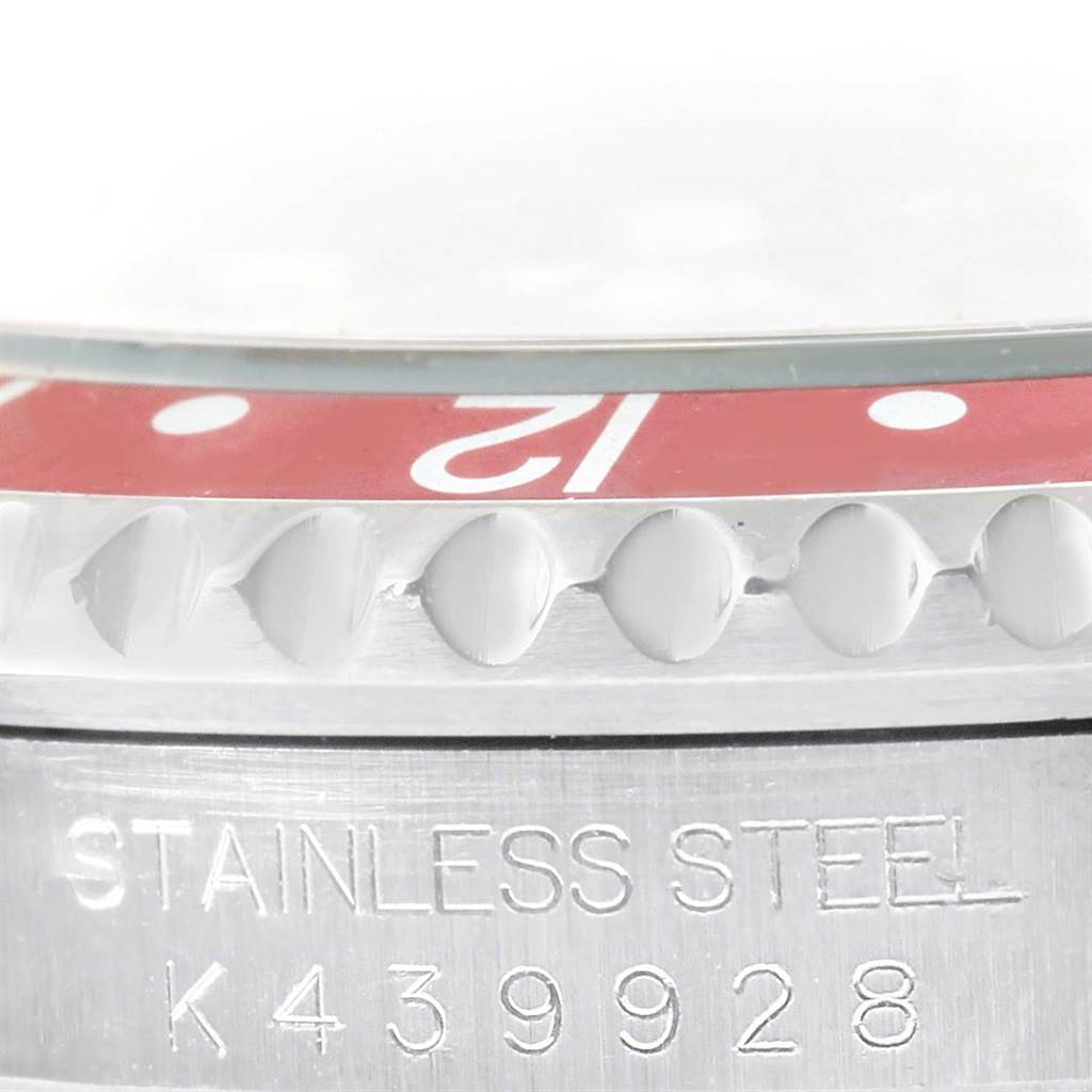 The image shows a close-up of the bezel and case side of a Rolex GMT-Master 16710 Men's Stainless Steel Black Dial 16710 Men's Stainless Steel Black Dial, highlighting the "12" marker and the "STAINLESS STEEL" engraving.