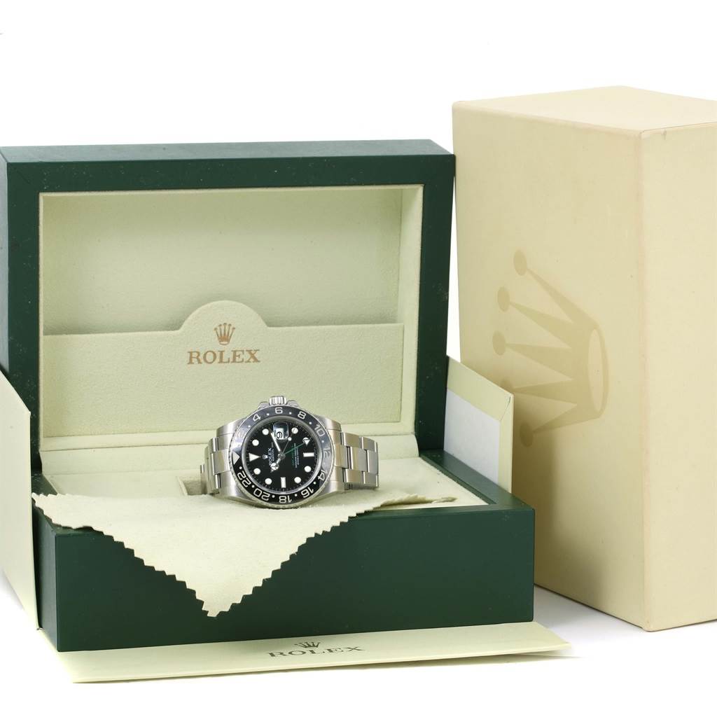 The Rolex GMT-Master 116710 Men's Stainless Steel Black Dial 116710 Men's Stainless Steel Black Dial watch is displayed front-facing in its open green and beige box, with an outer beige box shown beside it.