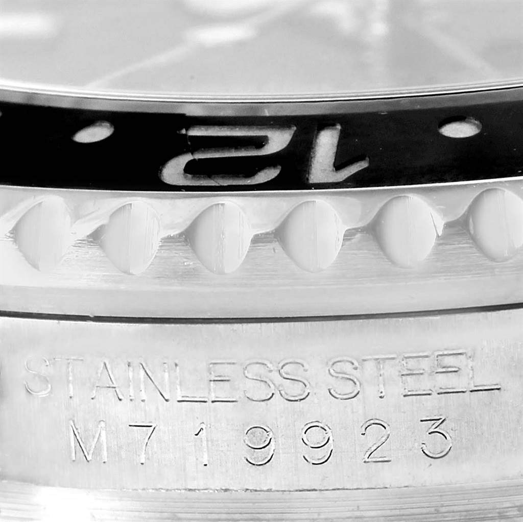This image shows a close-up of the bezel and case side of a Rolex GMT-Master 116710 Men's Stainless Steel Black Dial 116710 Men's Stainless Steel Black Dial watch, highlighting "STAINLESS STEEL M719923."