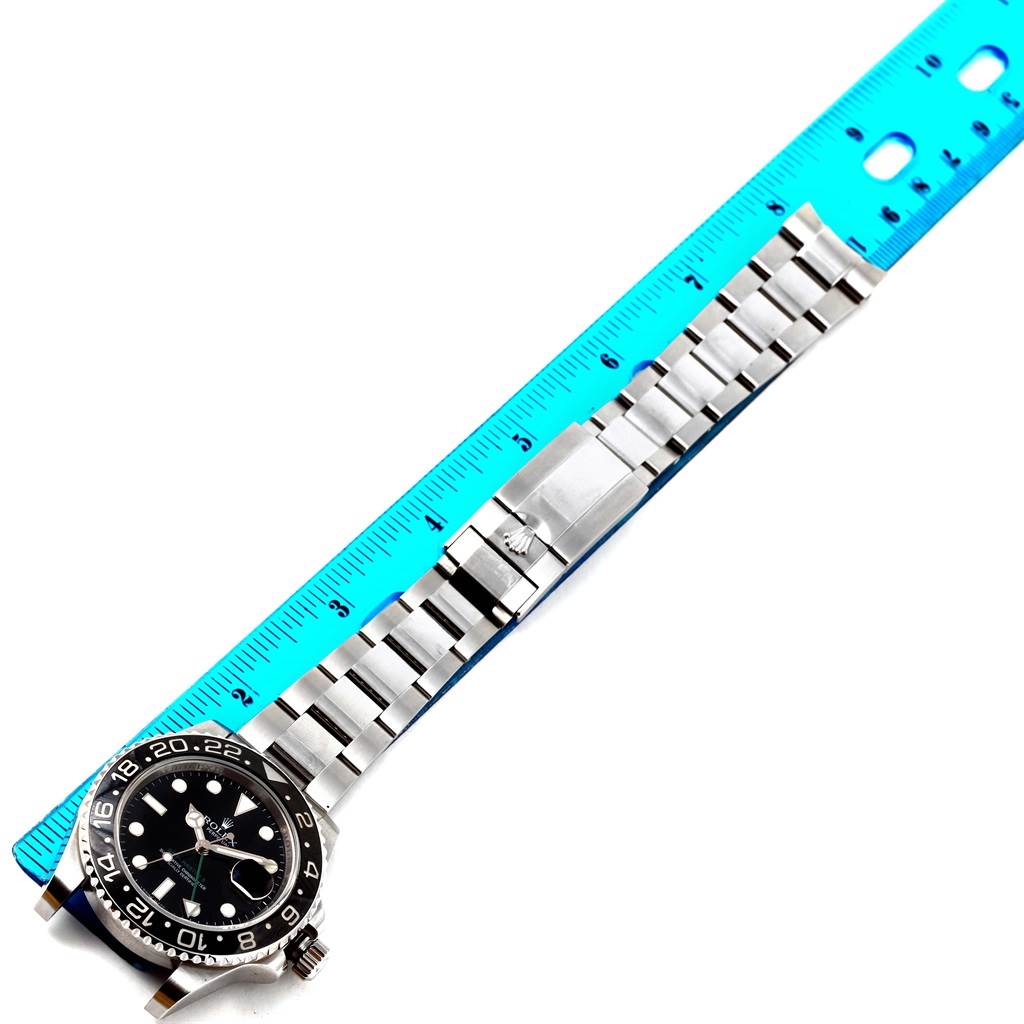 The image shows a Rolex GMT-Master 116710 Men's Stainless Steel Black Dial 116710 Men's Stainless Steel Black Dial watch laid flat with a blue ruler measuring the bracelet length.