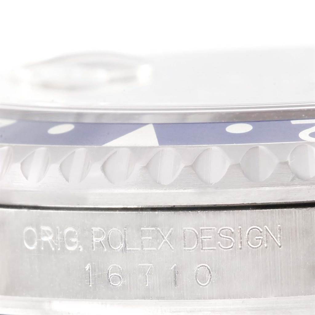 This image shows a close-up view of the bezel and engraving on the side of a Rolex GMT-Master 16710 Men's Stainless Steel Black Dial 16710 Men's Stainless Steel Black Dial model.