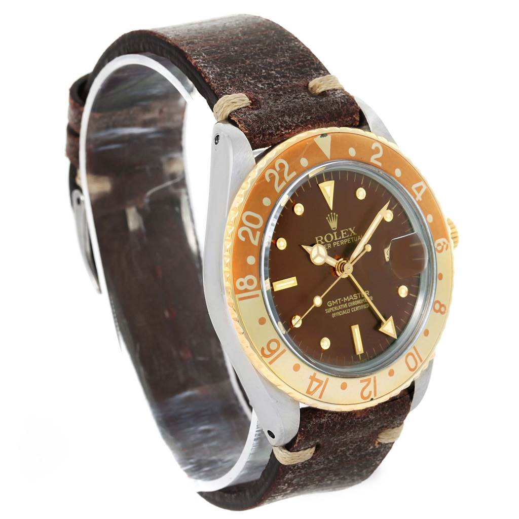 The Rolex GMT-Master 16753 Men's Stainless Steel Brown Dial 16753 Men's Stainless Steel Brown Dial watch is shown at an angle highlighting its face, bezel, and brown leather strap.