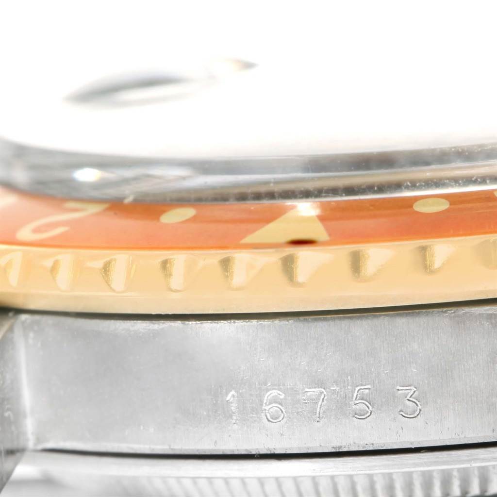 This close-up shows the side of the bezel, crystal, and case with model number of the Rolex GMT-Master 16753 Men's Stainless Steel Brown Dial 16753 Men's Stainless Steel Brown Dial.