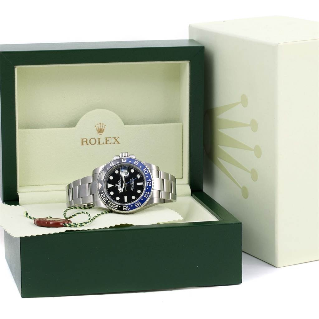 The Rolex GMT-Master 116710 Men's Stainless Steel Black Dial 116710 Men's Stainless Steel Black Dial watch is shown at a front angle, displayed in its green box with the outer box next to it.