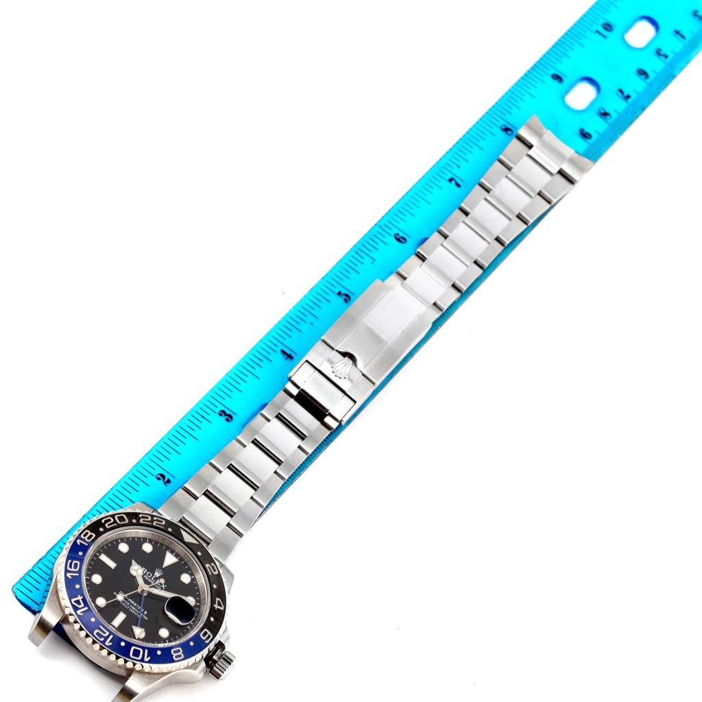 The image shows a flat, top-down view of a Rolex GMT-Master 116710 Men's Stainless Steel Black Dial 116710 Men's Stainless Steel Black Dial watch with a ruler measuring its stainless steel bracelet.