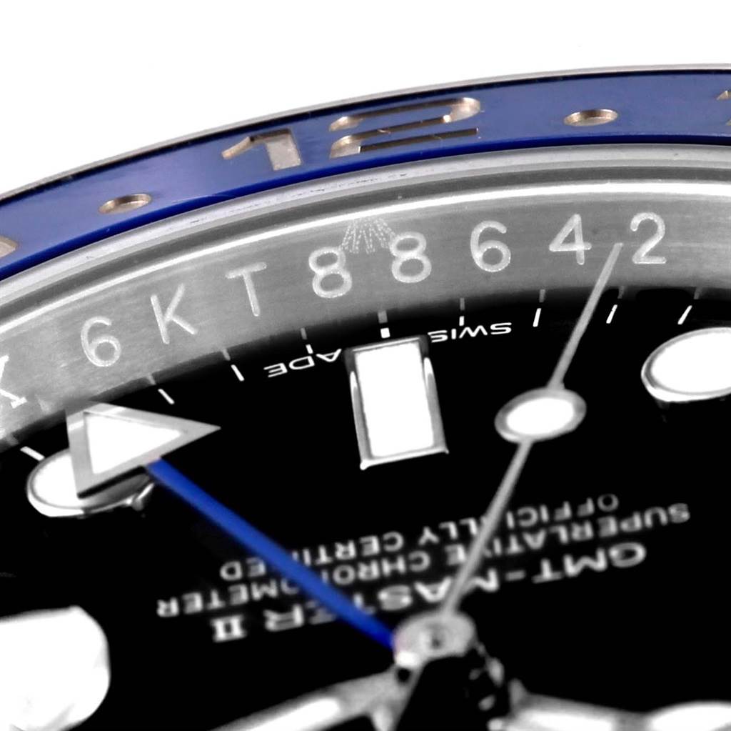 This close-up image shows the dial, part of the bezel, a portion of the indices, and hands of the Rolex GMT-Master 116710 Men's Stainless Steel Black Dial 116710 Men's Stainless Steel Black Dial watch.