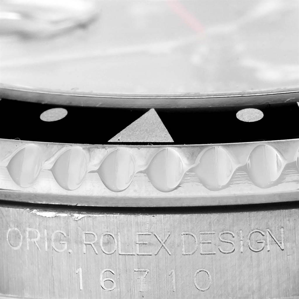 This image shows a close-up view of the bezel and case with the 'ORIG. ROLEX DESIGN 16710' inscription on a Rolex GMT-Master 16710 Men's Stainless Steel Black Dial 16710 Men's Stainless Steel Black Dial watch.