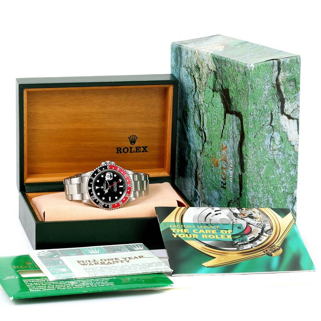 The Rolex GMT-Master 16710 Men's Stainless Steel Black Dial 16710 Men's Stainless Steel Black Dial watch is shown in its box along with the outer box and accompanying manuals and warranty card.
