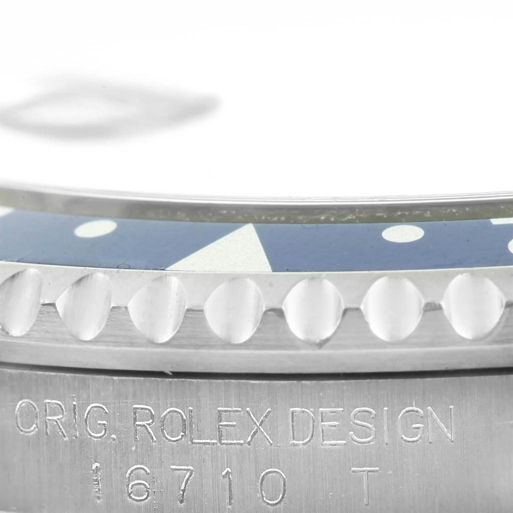 The image shows a close-up of the Rolex GMT-Master 16710 Men's Stainless Steel Black Dial 16710 Men's Stainless Steel Black Dial watch bezel and case with the model number 16710 etched on it.