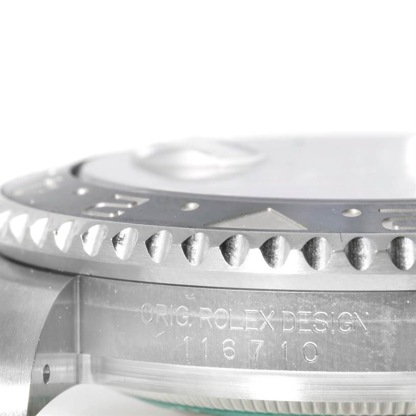 This image shows a close-up side view of the bezel and engraved part of the case of a Rolex GMT-Master 116710 Men
s Stainless Steel Black Dial 116710 Men
s Stainless Steel Black Dial watch.