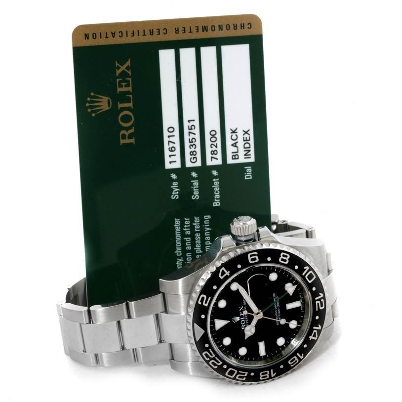 The image shows a Rolex GMT-Master 116710 Men
s Stainless Steel Black Dial 116710 Men
s Stainless Steel Black Dial watch face and band, alongside its green certification card.