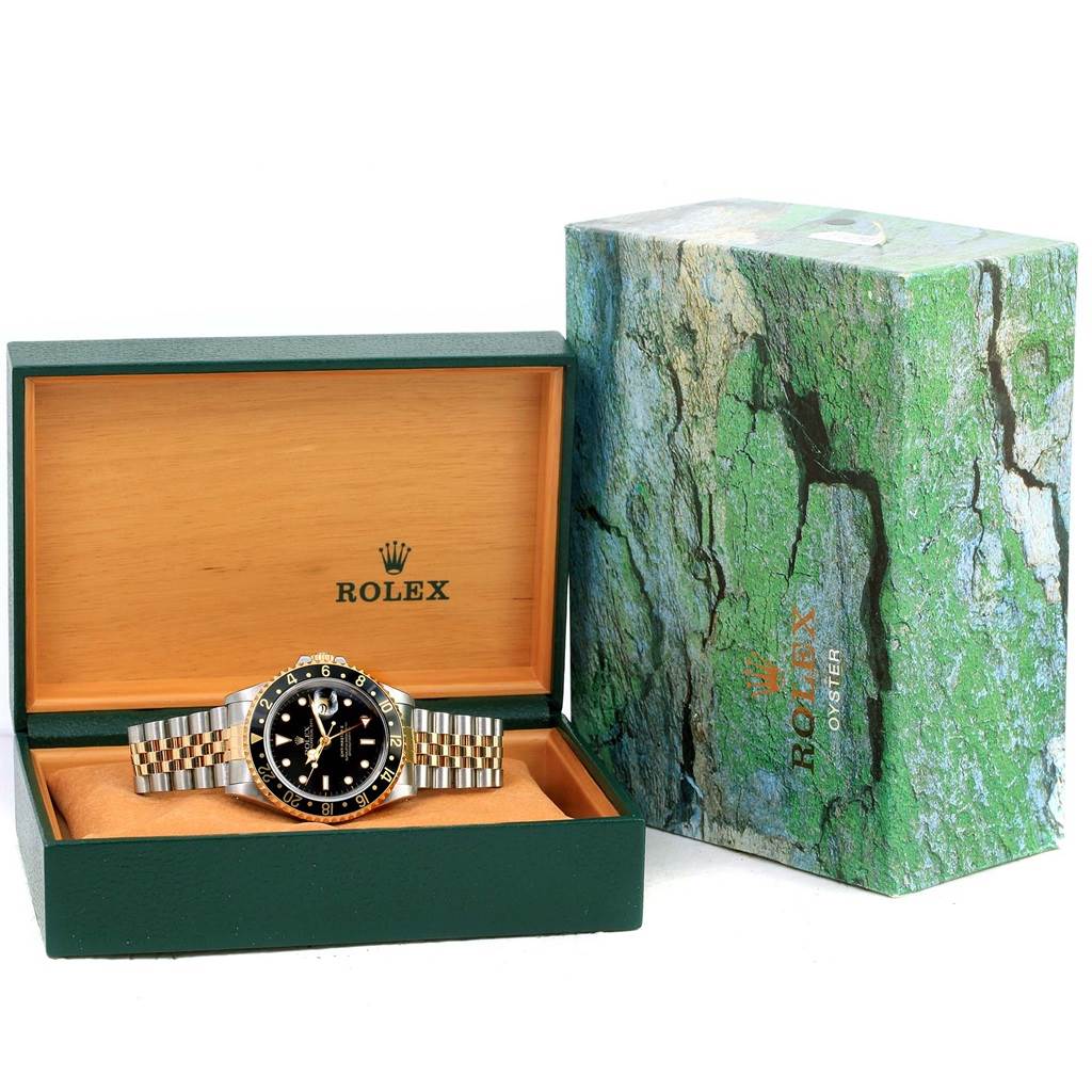 This image shows a Rolex GMT-Master 16713 Men's Stainless Steel Black Dial 16713 Men's Stainless Steel Black Dial watch, its band, and a branded box with the lid open, revealing the watch inside.