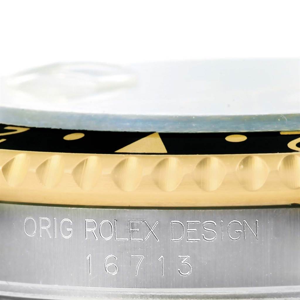 This image shows a close-up of the bezel and case side of the Rolex GMT-Master 16713 Men's Stainless Steel Black Dial 16713 Men's Stainless Steel Black Dial, model 16713, with the engraved text visible.