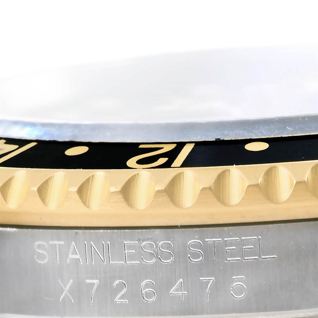 This image shows a close-up of the bezel, identifying engravings, and part of the case of the Rolex GMT-Master 16713 Men's Stainless Steel Black Dial 16713 Men's Stainless Steel Black Dial watch.