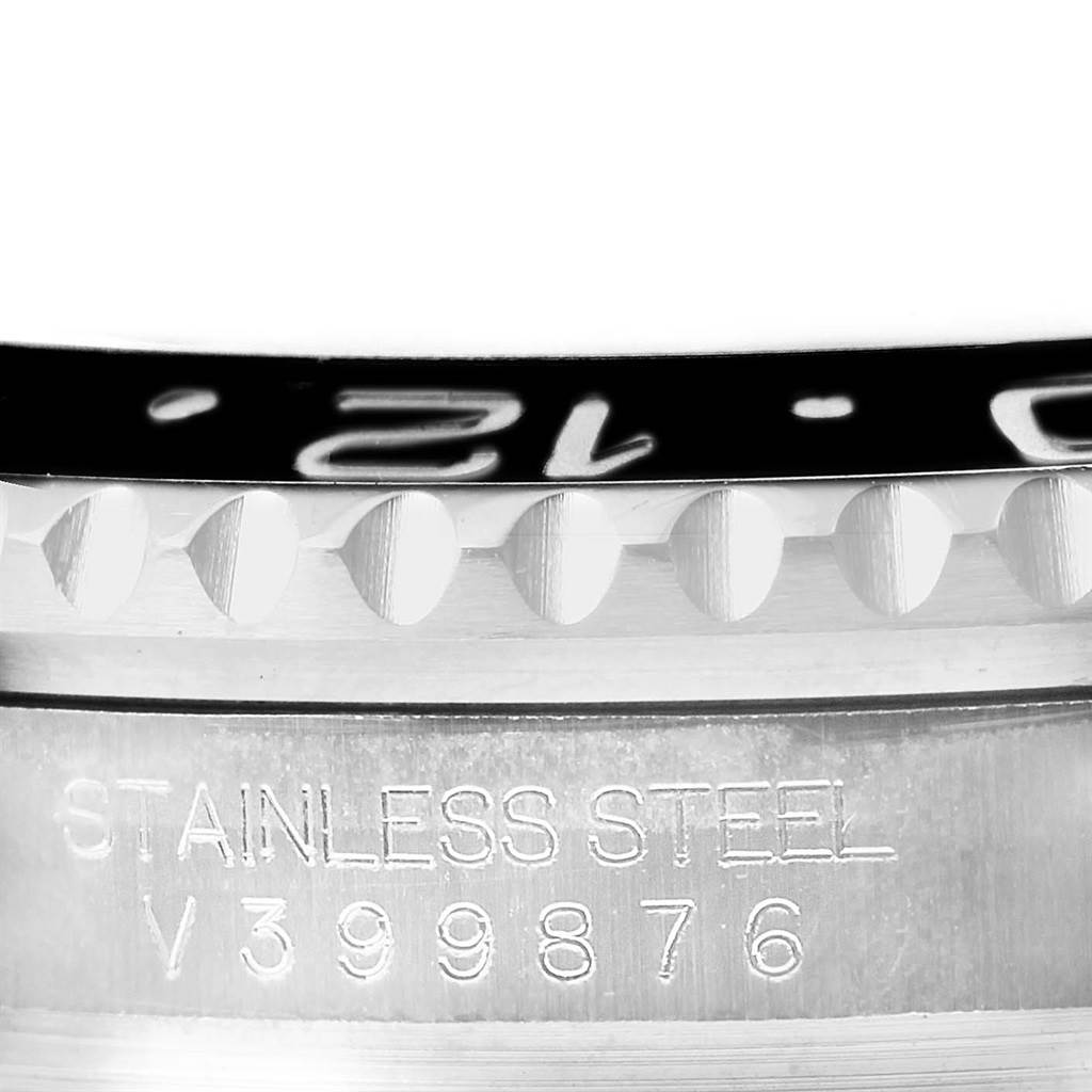 The image shows a close-up of the bezel and case of a Rolex GMT-Master 116710 Men's Stainless Steel Black Dial 116710 Men's Stainless Steel Black Dial watch, highlighting the stainless steel material and serial number.