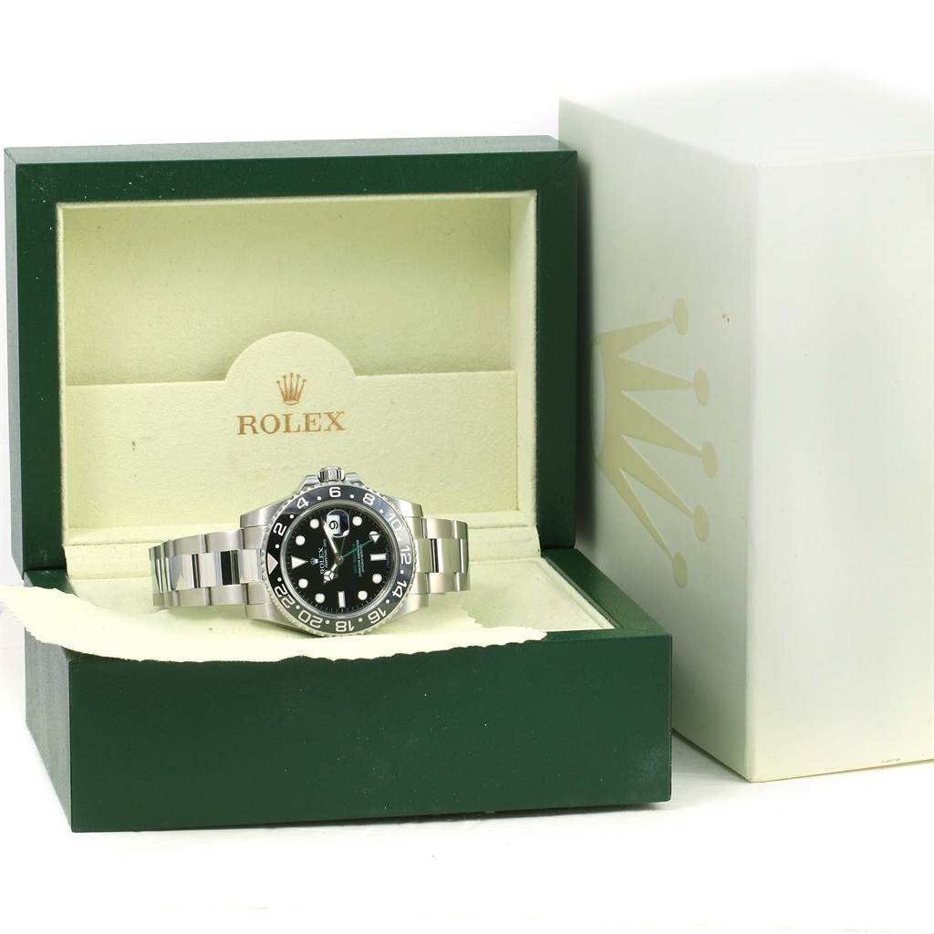 The Rolex GMT-Master 116710 Men's Stainless Steel Black Dial 116710 Men's Stainless Steel Black Dial watch is shown from the front with its stainless steel bracelet, displayed inside its green Rolex box.