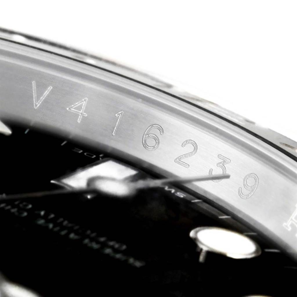 The image shows a close-up of the serial number etched on the rehaut of a Rolex GMT-Master 116710 Men's Stainless Steel Black Dial 116710 Men's Stainless Steel Black Dial watch.