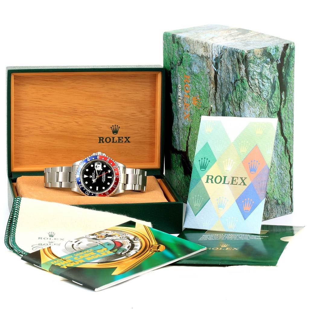 The image shows a Rolex GMT-Master 16710 Men's Stainless Steel Black Dial 16710 Men's Stainless Steel Black Dial watch, presented in its box with accompanying booklets and accessories.