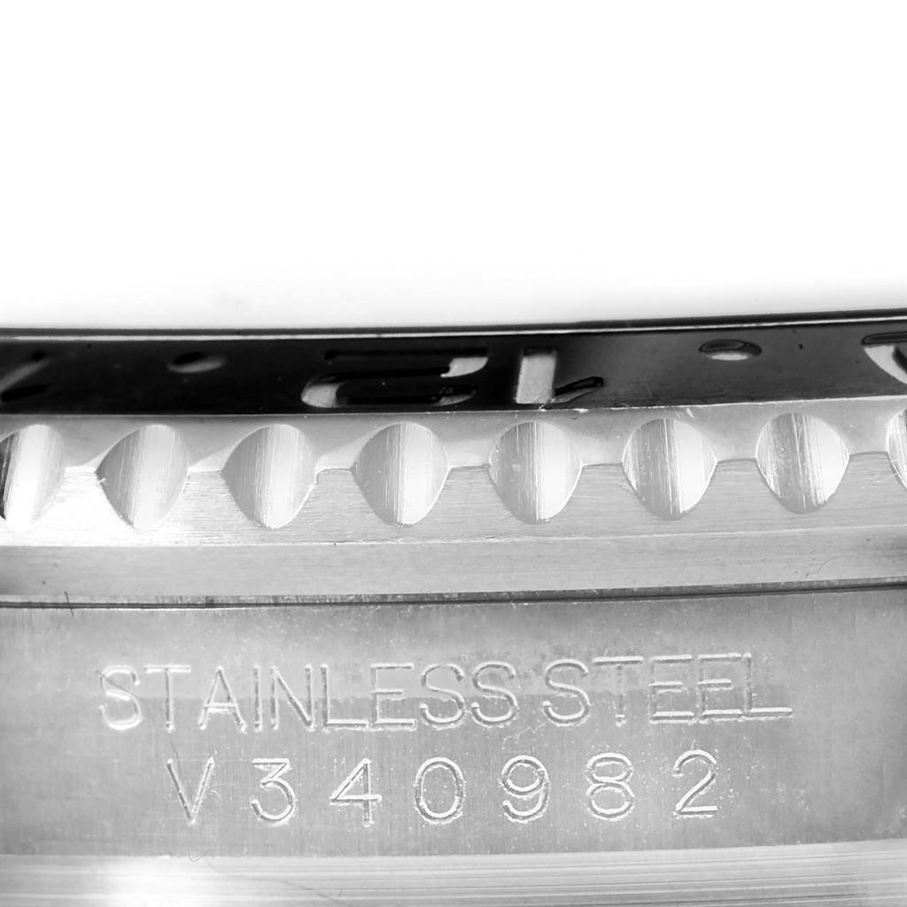 The image shows a macro view of the stainless steel case and bezel with the serial number of a Rolex GMT-Master 116710 Men's Stainless Steel Black Dial 116710 Men's Stainless Steel Black Dial watch.