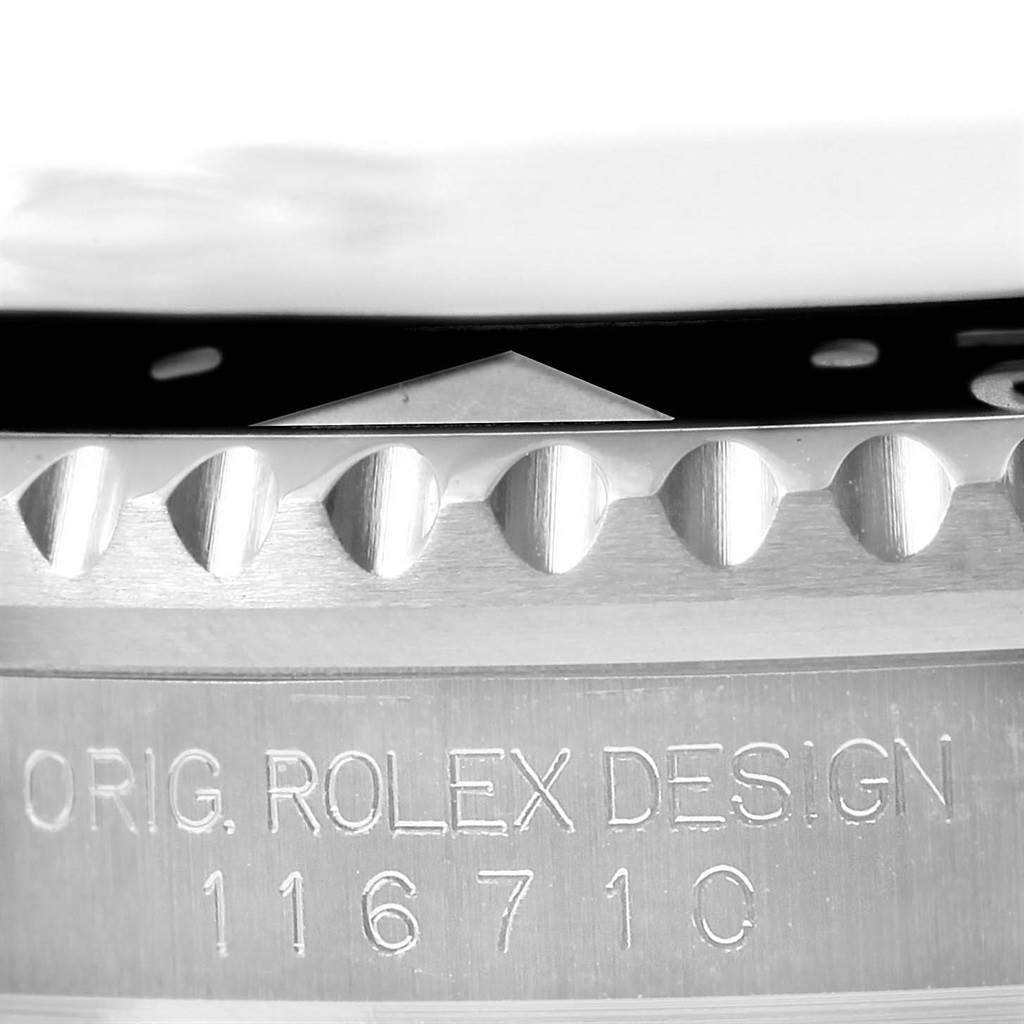 This close-up image shows the engravings and the bezel edge of a Rolex GMT-Master 116710 Men's Stainless Steel Black Dial 116710 Men's Stainless Steel Black Dial model.