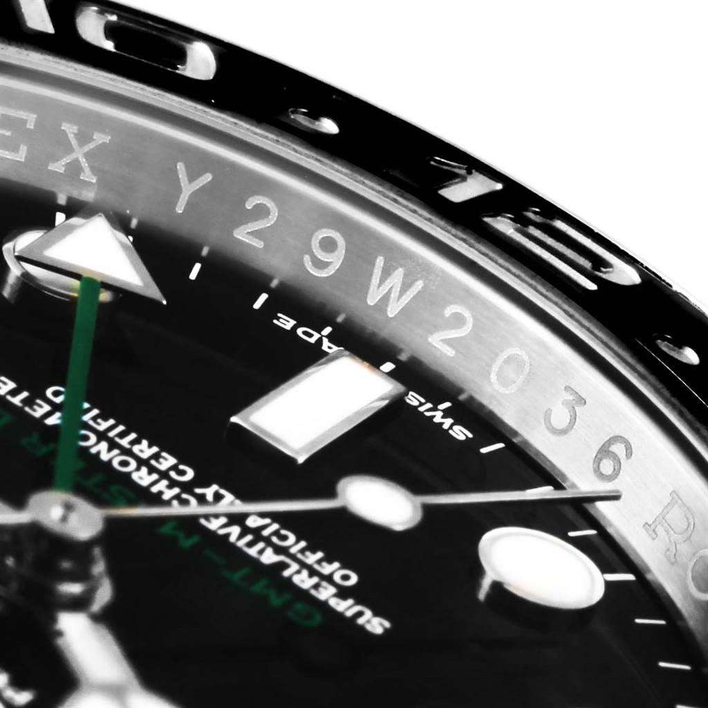This close-up angle of a Rolex GMT-Master 116710 Men
s Stainless Steel Black Dial 116710 Men
s Stainless Steel Black Dial watch shows part of the dial, hands, and engraved inner bezel with a partial serial number.