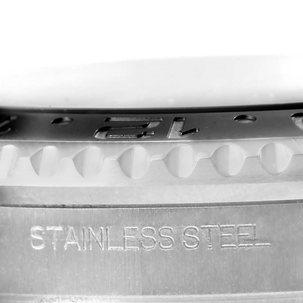 The image shows a close-up of the bezel and edge of the case of a Rolex GMT-Master 116710 Men
s Stainless Steel Black Dial 116710 Men
s Stainless Steel Black Dial watch with the "STAINLESS STEEL" engraving visible.