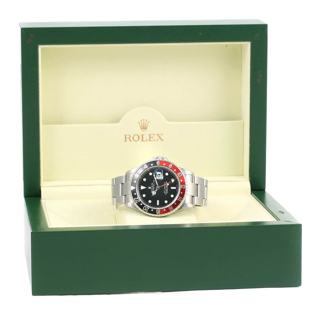 The Rolex GMT-Master 16710 Men's Stainless Steel Black Dial 16710 Men's Stainless Steel Black Dial watch is displayed front-on in its green and beige presentation box.