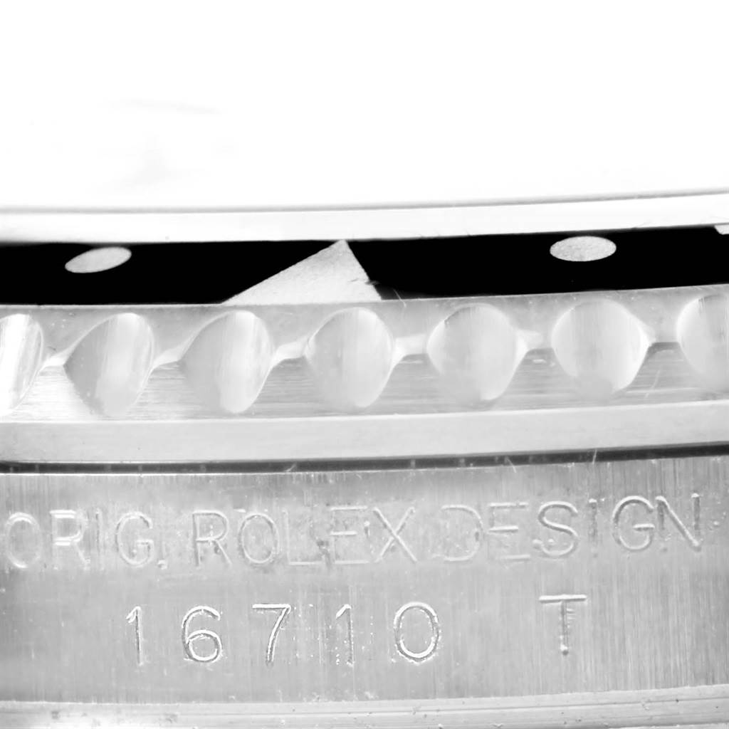 This close-up shows the bezel and serial number engraving on a Rolex GMT-Master 16710 Men's Stainless Steel Black Dial 16710 Men's Stainless Steel Black Dial watch.