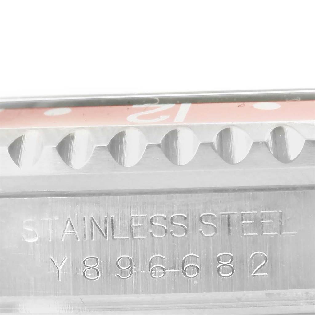 This close-up image shows the stainless steel case with the bezel edge and serial number of the Rolex GMT-Master 16710 Men's Stainless Steel Black Dial 16710 Men's Stainless Steel Black Dial watch.