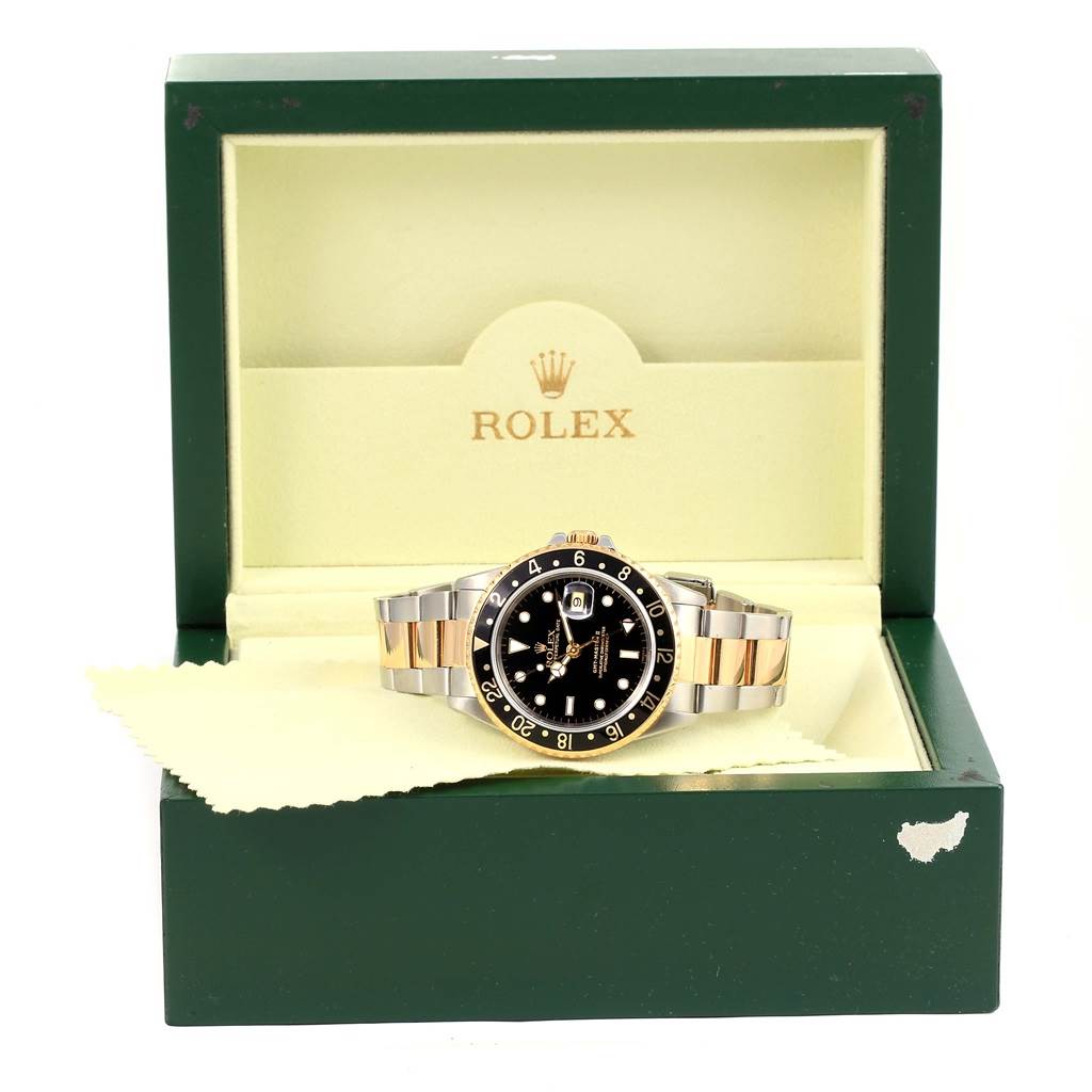 The Rolex GMT-Master 16713 Men's Stainless Steel Black Dial 16713 Men's Stainless Steel Black Dial watch is shown positioned in its open, green branded box, viewed from the front.