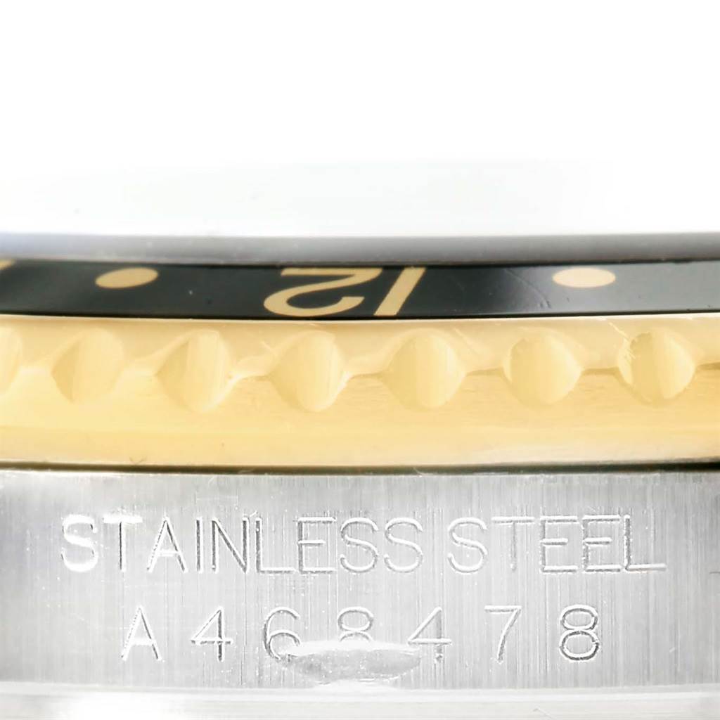 The image shows a close-up of the bezel, serial number, and part of the case of a Rolex GMT-Master 16713 Men's Stainless Steel Black Dial 16713 Men's Stainless Steel Black Dial watch.