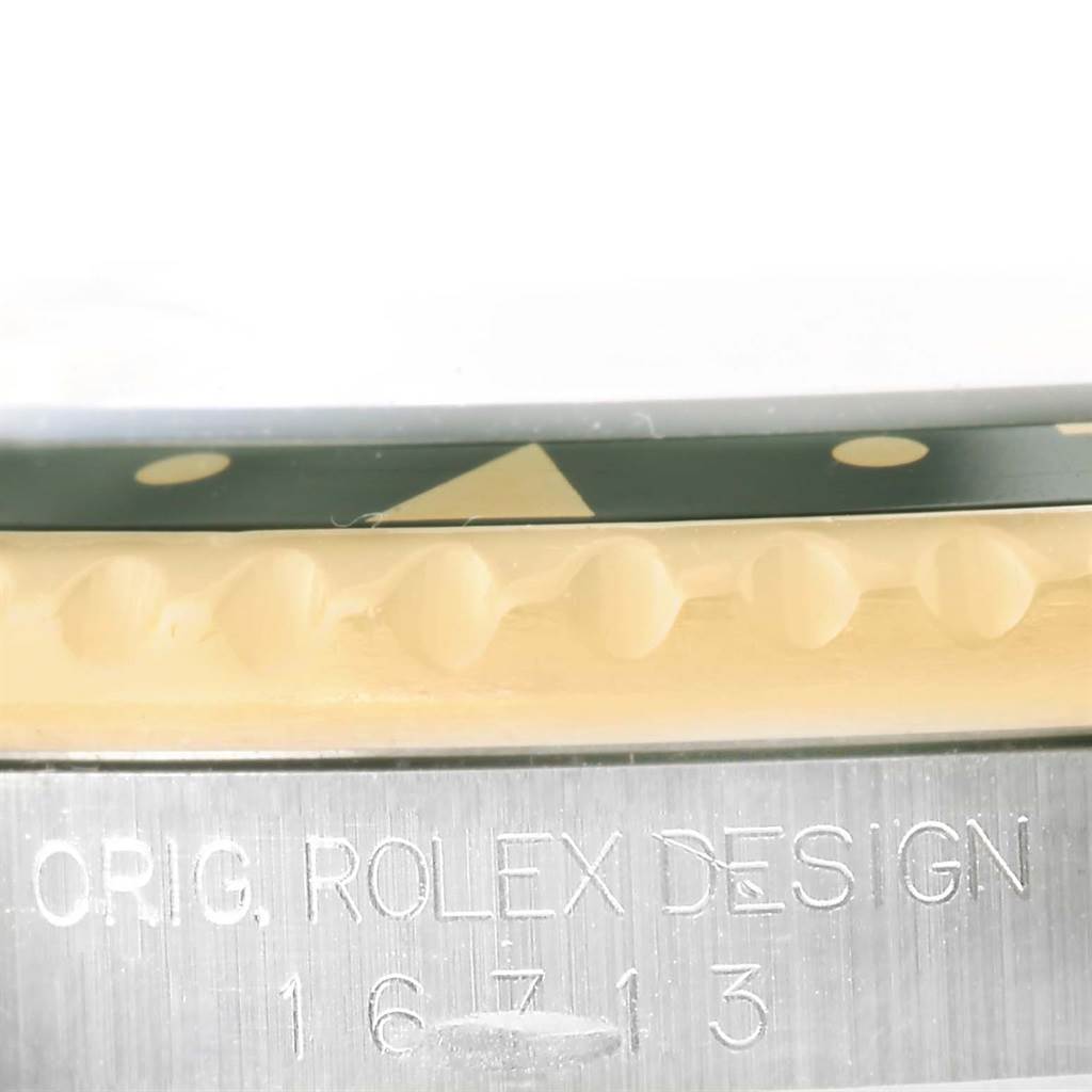 This image shows a close-up view of the side of a Rolex GMT-Master 16713 Men's Stainless Steel Black Dial 16713 Men's Stainless Steel Black Dial watch, highlighting the bezel and engraved model number.