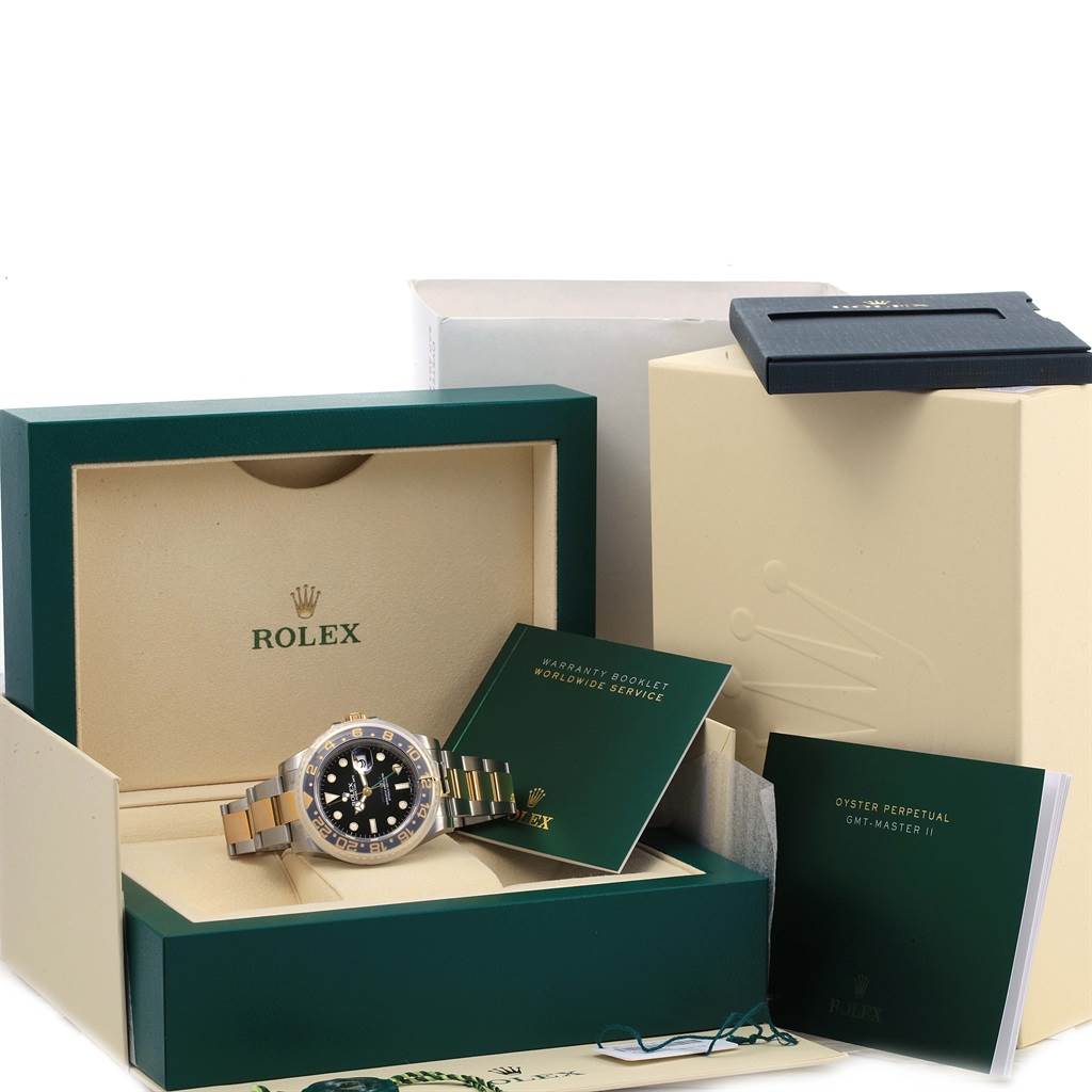 The Rolex GMT-Master 116713 Men's Stainless Steel Black Dial 116713 Men's Stainless Steel Black Dial watch is displayed in its box along with booklets and additional packaging materials.