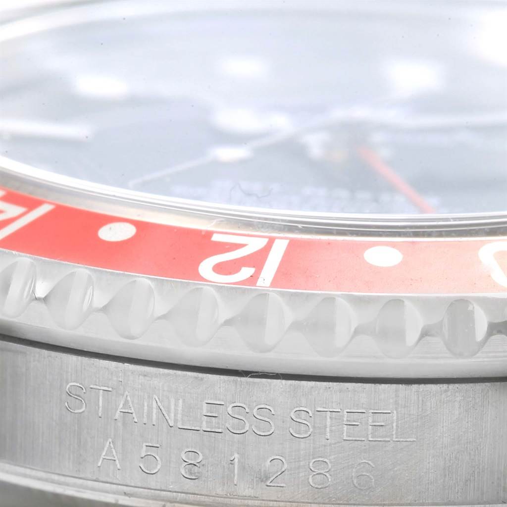 This image shows a close-up of the bezel and side case of a Rolex GMT-Master 16700 Men's Stainless Steel Black Dial 16700 Men's Stainless Steel Black Dial watch, highlighting the stainless steel and engravings.