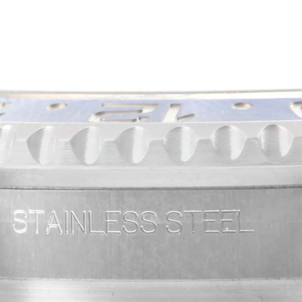 The image shows a close-up of the bezel and case of a Rolex GMT-Master 116710 Men
s Stainless Steel Black Dial 116710 Men
s Stainless Steel Black Dial watch, highlighting the stainless steel material.