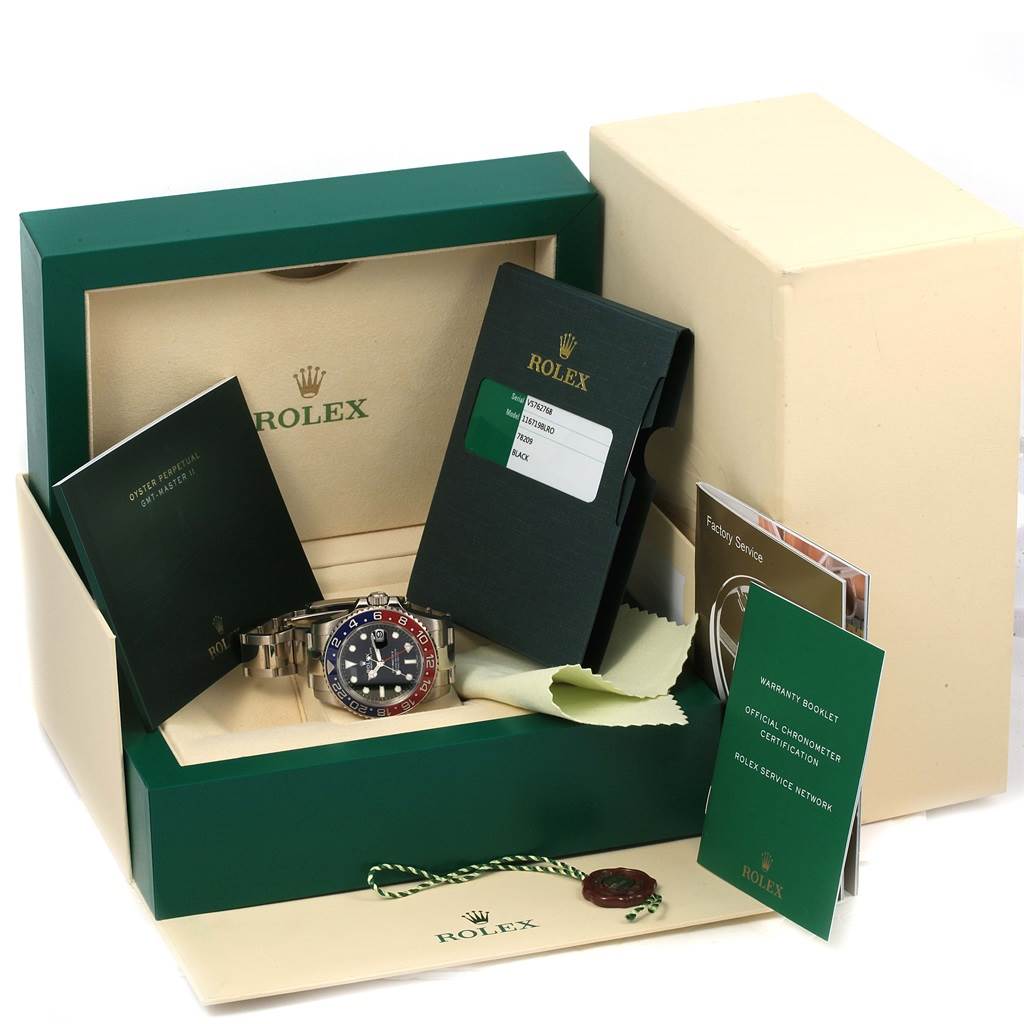 The image shows a Rolex GMT-Master 116719 Men
s White Gold Black Dial 116719 Men
s White Gold Black Dial watch with its original box, warranty card, booklets, and accessories from a straight-on angle.