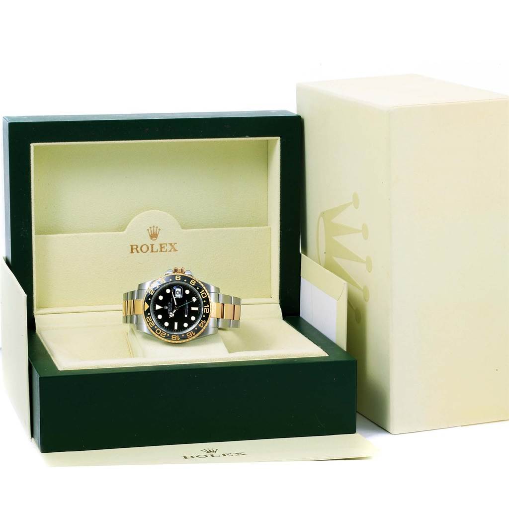 The Rolex GMT-Master 116713 Men's Stainless Steel Black Dial 116713 Men's Stainless Steel Black Dial watch is displayed front-on in an open box, showing its face and bracelet prominently.